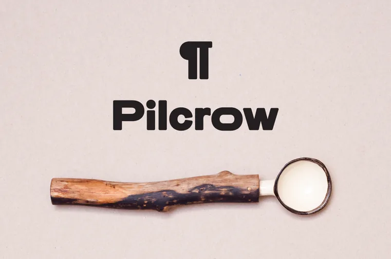 Pilcrow wordmark above a wooden-handled magnifying glass